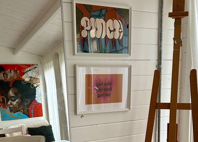 Cozy corner at Pinch Nails, London, England, GB featuring vibrant wall art and signage.