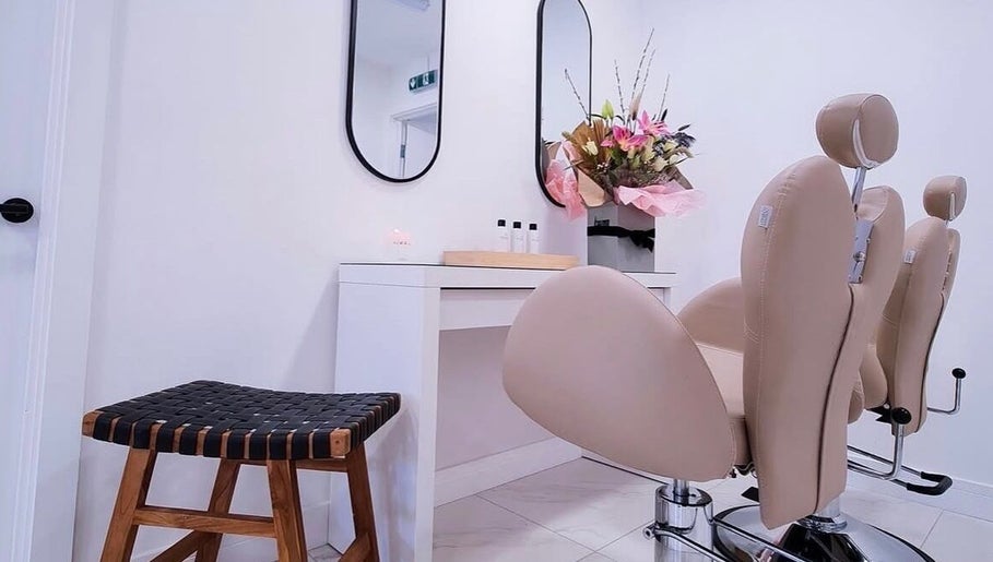 Elegant salon setup at Bella Beauty By Sarah, Merthyr Tydfil, Wales, GB with stylish chairs and flowers.