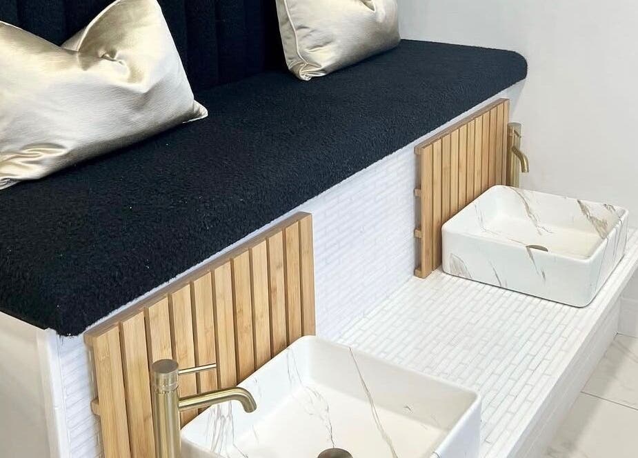Luxurious pedicure area at Bella Beauty By Sarah, Merthyr Tydfil, Wales, GB with white basins and gold faucets.
