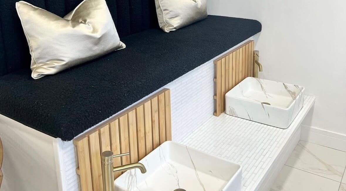 Luxurious pedicure area at Bella Beauty By Sarah, Merthyr Tydfil, Wales, GB with white basins and gold faucets.