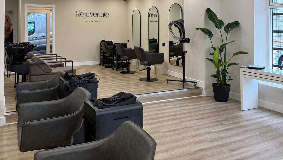 Modern salon interior at Rejuvenate@45, Stockport, England, GB with stylish chairs and mirrors.
