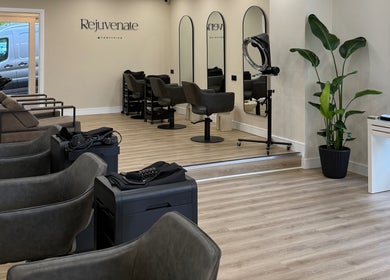 Modern salon interior at Rejuvenate@45, Stockport, England, GB with stylish chairs and mirrors.
