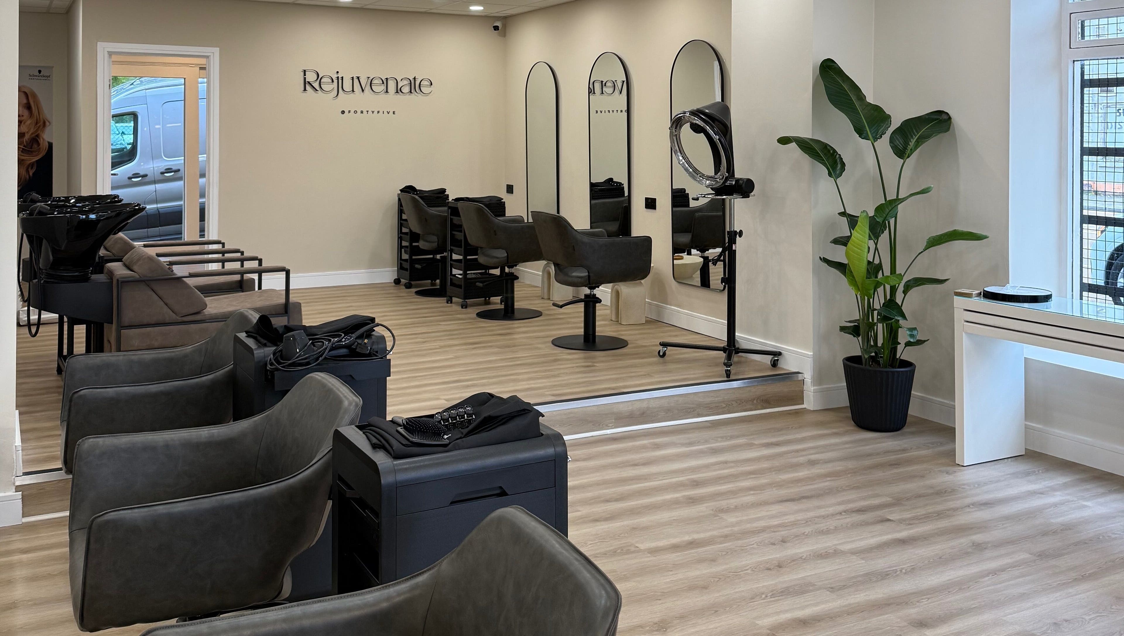 Spacious interior of Rejuvenate@45 salon in Stockport, England, GB, showcasing modern design and styling stations.
