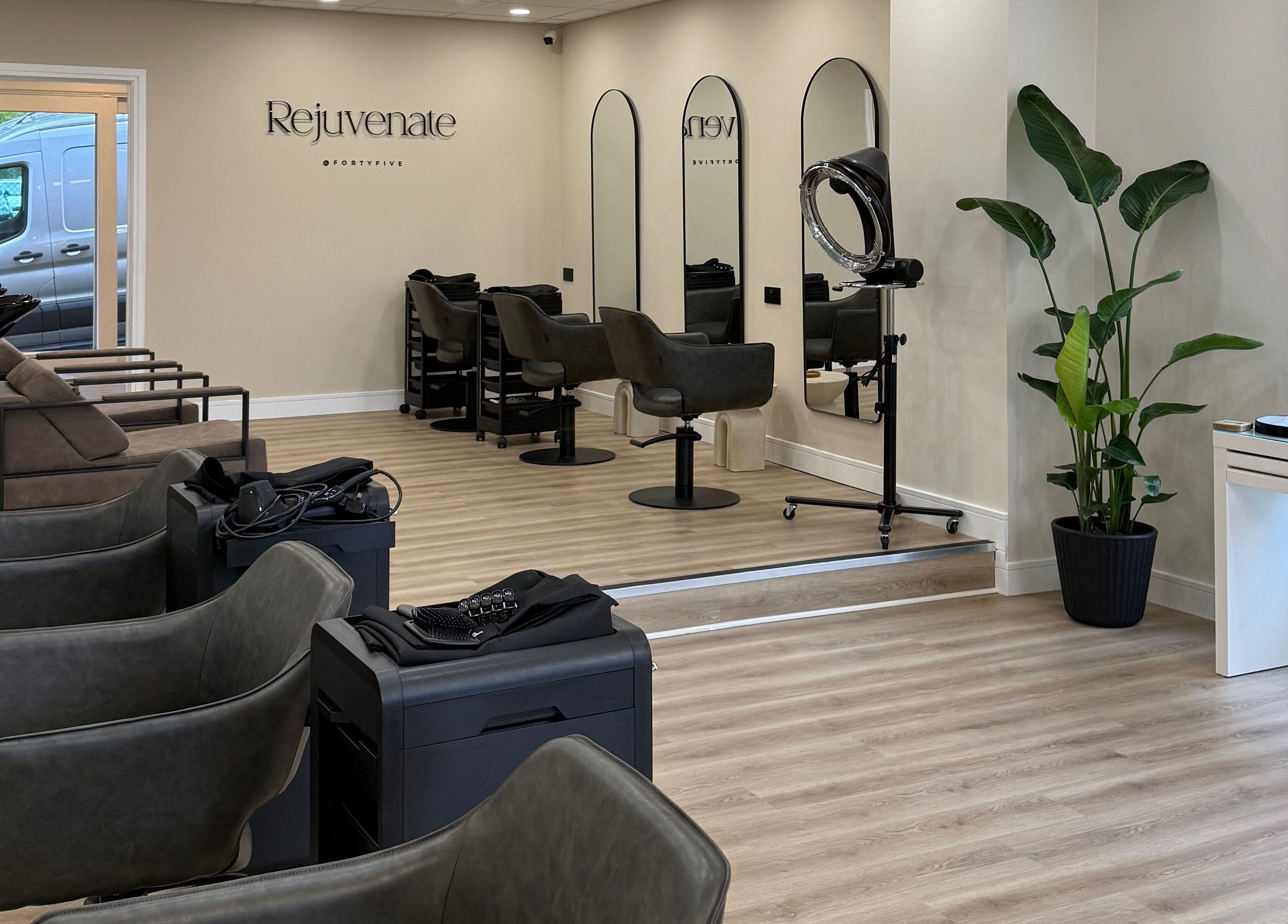 Spacious interior of Rejuvenate@45 salon in Stockport, England, GB, showcasing modern design and styling stations.