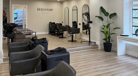 Spacious interior of Rejuvenate@45 salon in Stockport, England, GB, showcasing modern design and styling stations.