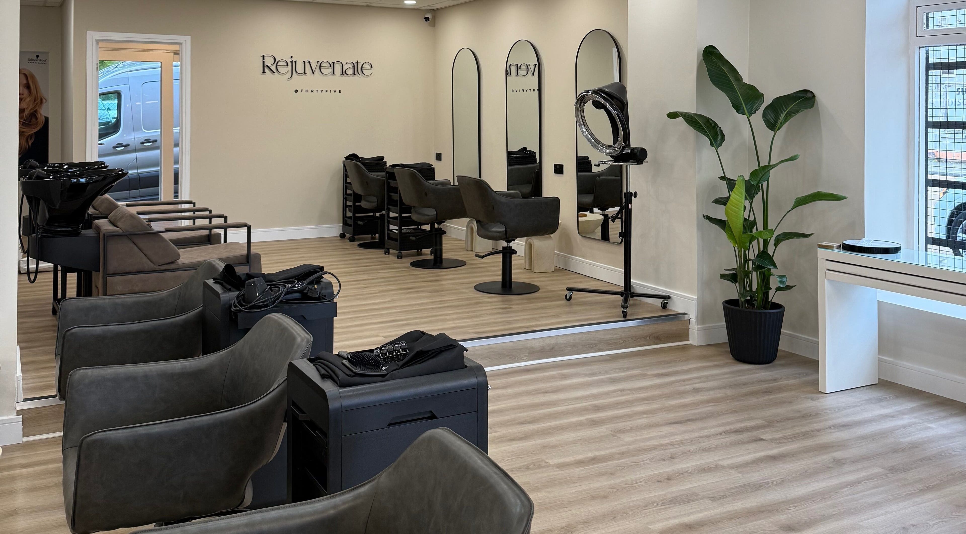 Spacious interior of Rejuvenate@45 salon in Stockport, England, GB, showcasing modern design and styling stations.