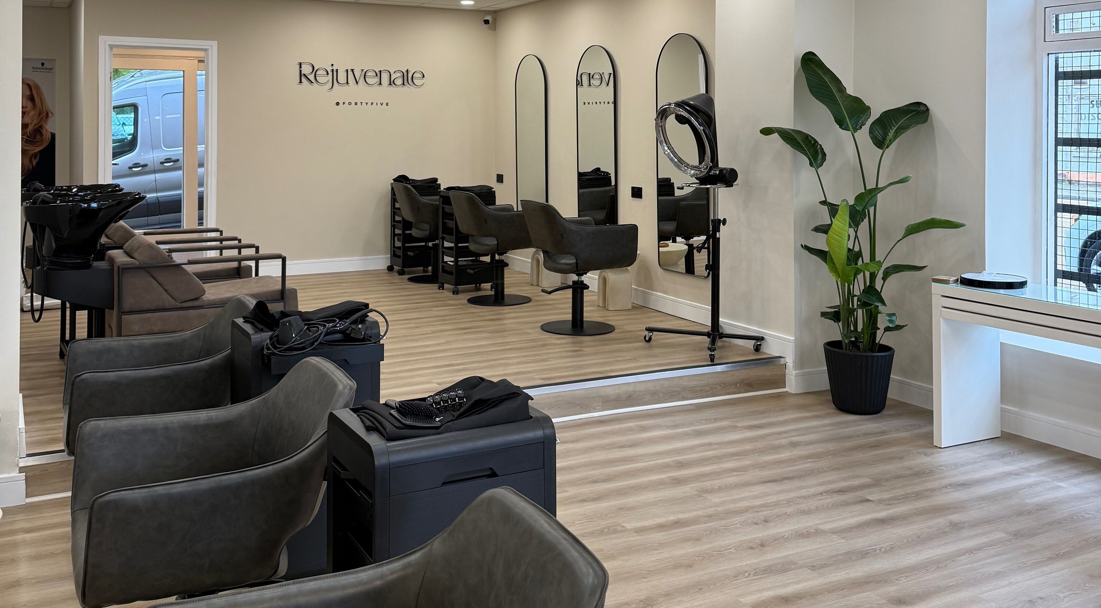 Spacious interior of Rejuvenate@45 salon in Stockport, England, GB, showcasing modern design and styling stations.