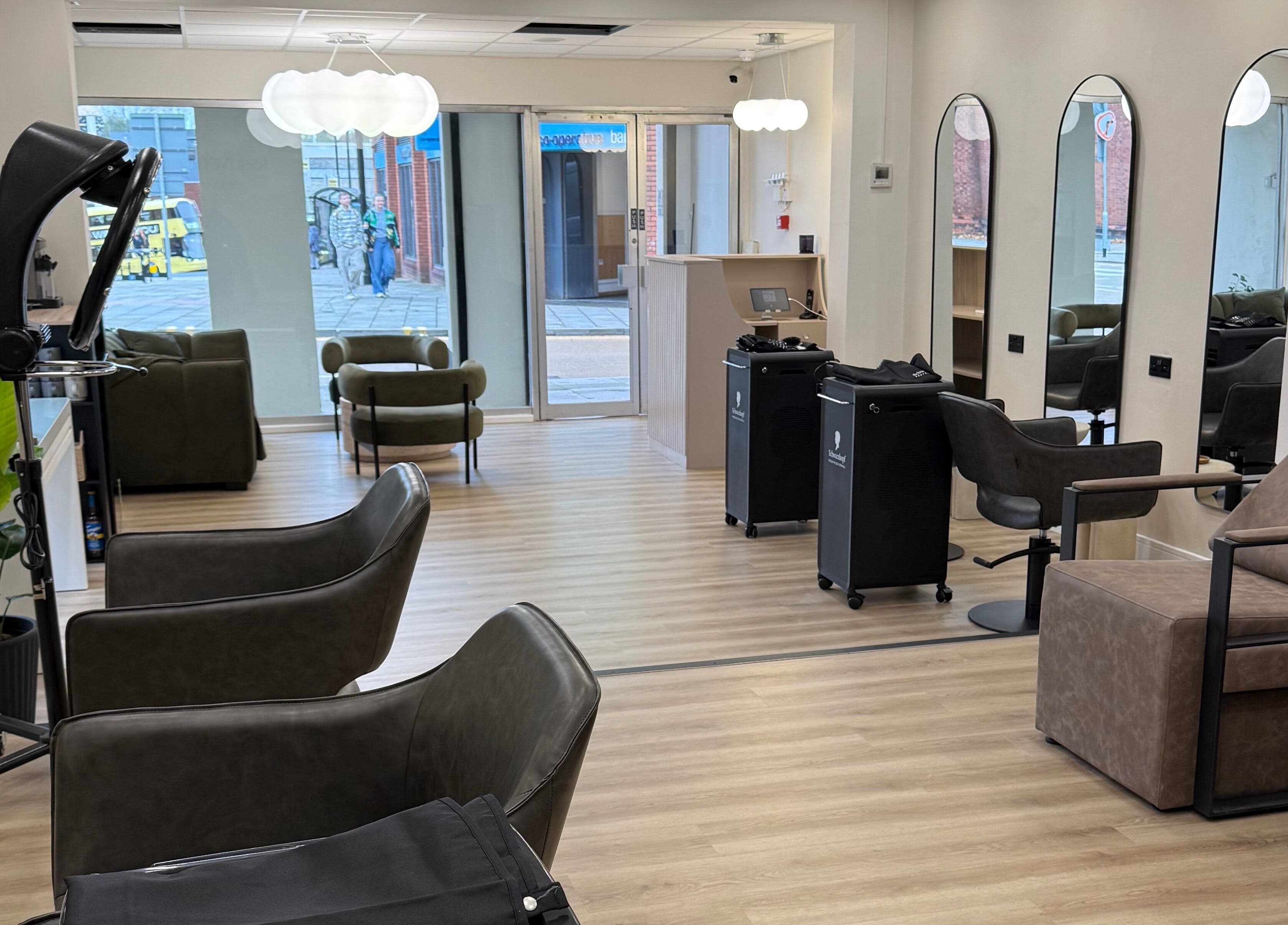 Modern salon interior at Rejuvenate@45, Stockport, England, GB, featuring sleek chairs and elegant decor.