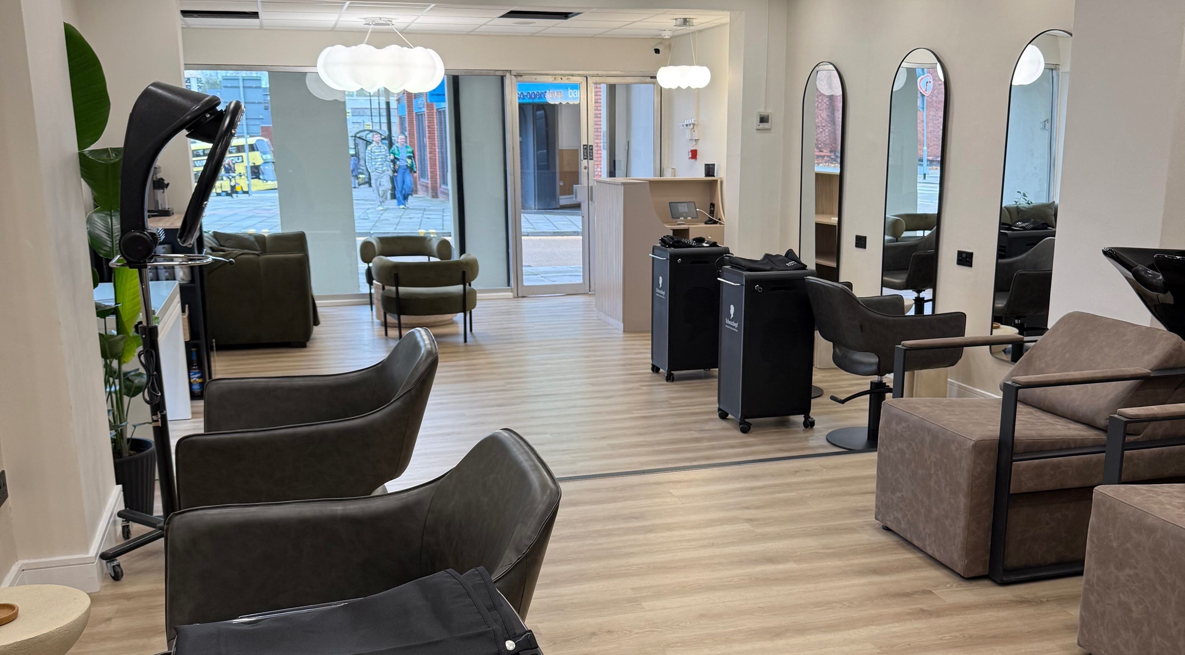 Modern salon interior at Rejuvenate@45, Stockport, England, GB, featuring sleek chairs and elegant decor.