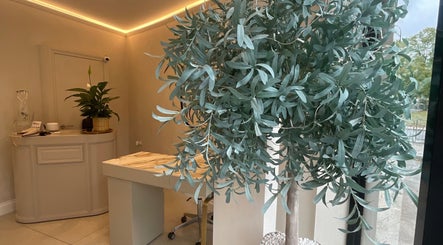 Elegant interior of Haus of Nails in Birmingham, England, GB, featuring stylish decor and lush greenery.