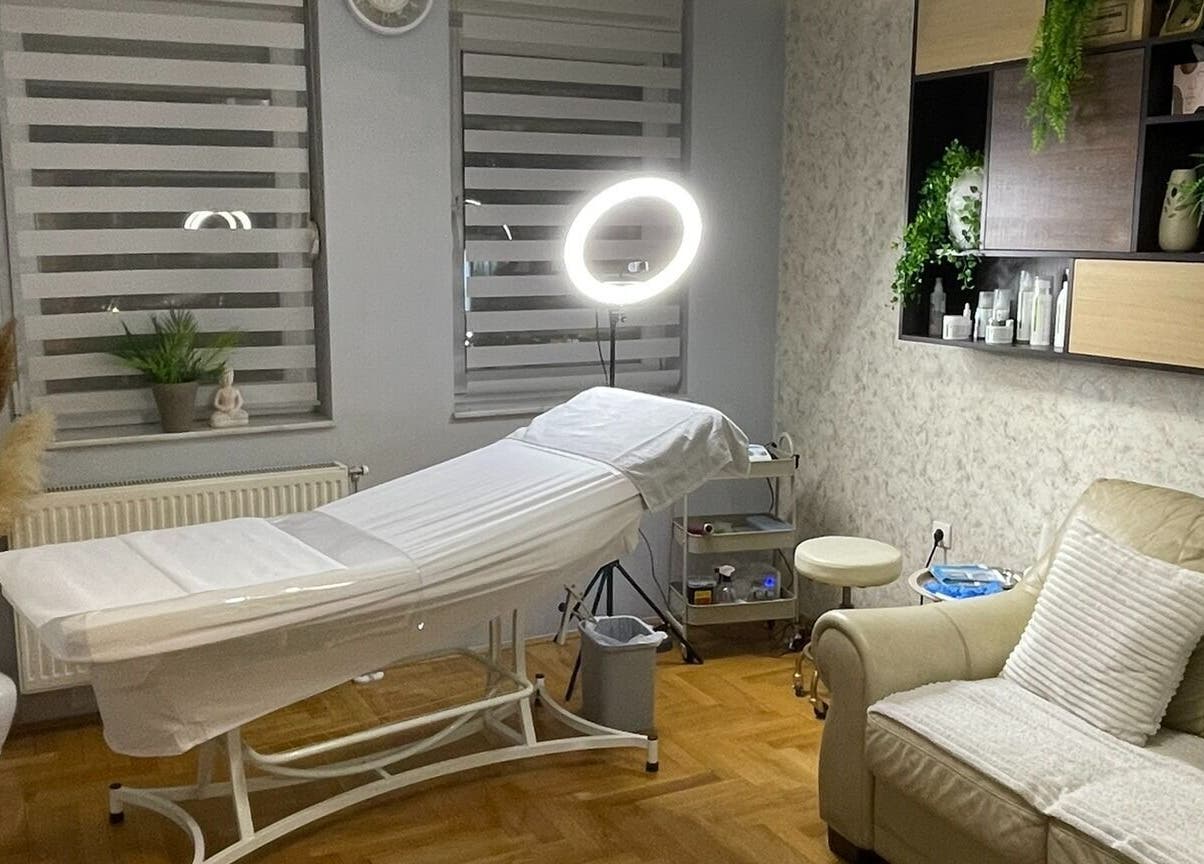 Calming treatment room at Senjochka MedSpa, Novi Sad, Vojvodina, RS with a cozy couch and treatment bed.