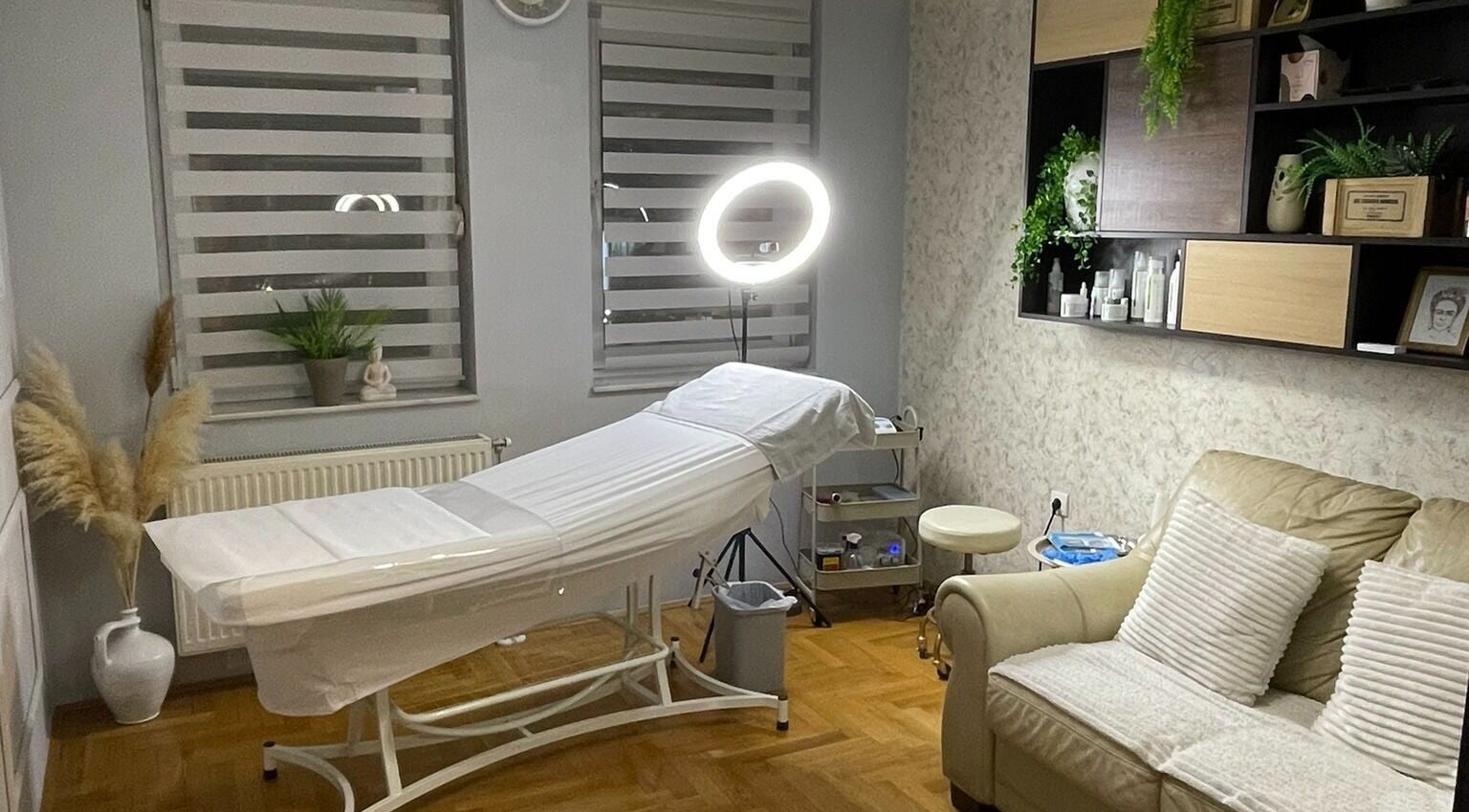Calming treatment room at Senjochka MedSpa, Novi Sad, Vojvodina, RS with a cozy couch and treatment bed.