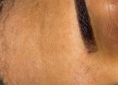 Expertly shaped eyebrow at Devinebrows, Manchester, England, GB, showcasing precision beauty treatment.