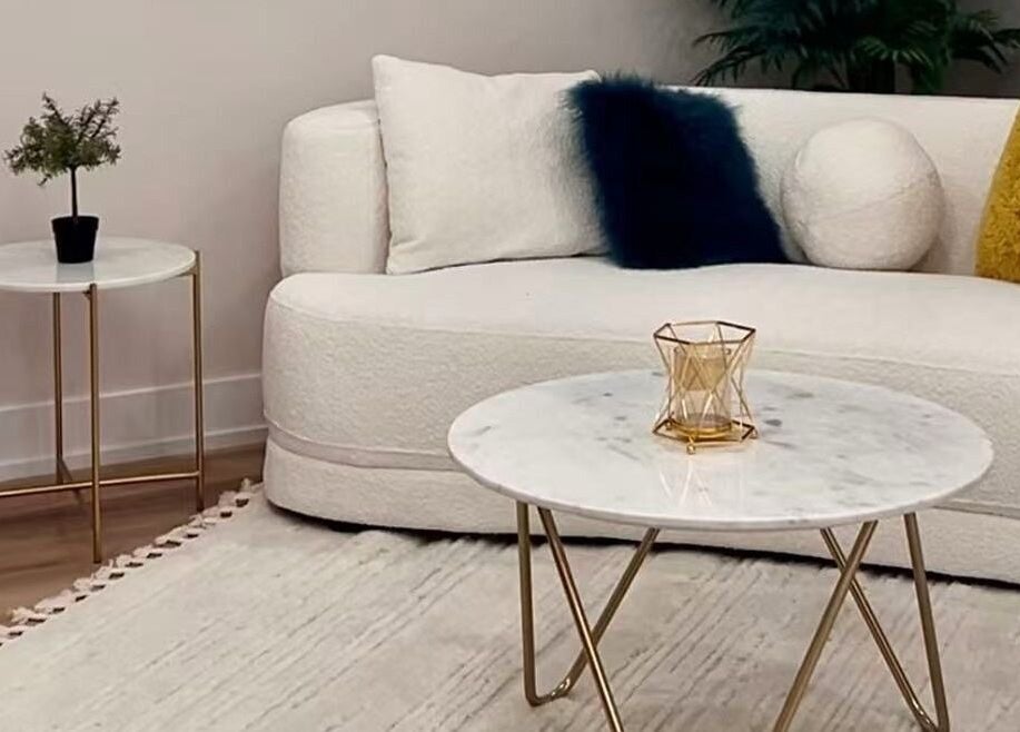 Sophisticated lounge area at LUMINA MEDI SPA, Mississauga, Ontario, CA, with plush sofa and marble tables.