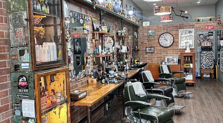 Cozy vintage barbershop interior at Suzathebarber, Millner, Northern Territory, AU, featuring classic chairs and decor.