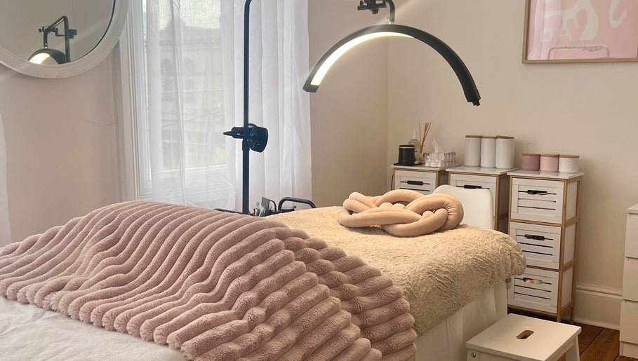 Cozy treatment room at Through Her Eyes in Melbourne, Victoria, AU with plush bedding and ambient lighting.