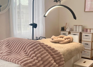 Cozy treatment room at Through Her Eyes in Melbourne, Victoria, AU with plush bedding and ambient lighting.