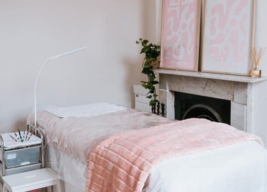 Tranquil spa room at Through Her Eyes with pink decor in Melbourne, Victoria, AU offering relaxation.