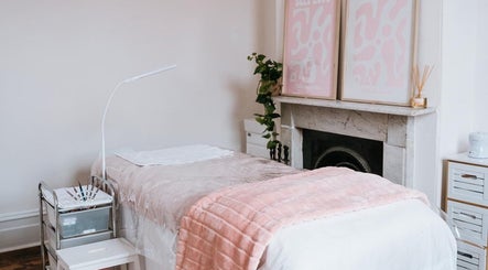 Tranquil spa room at Through Her Eyes with pink decor in Melbourne, Victoria, AU offering relaxation.