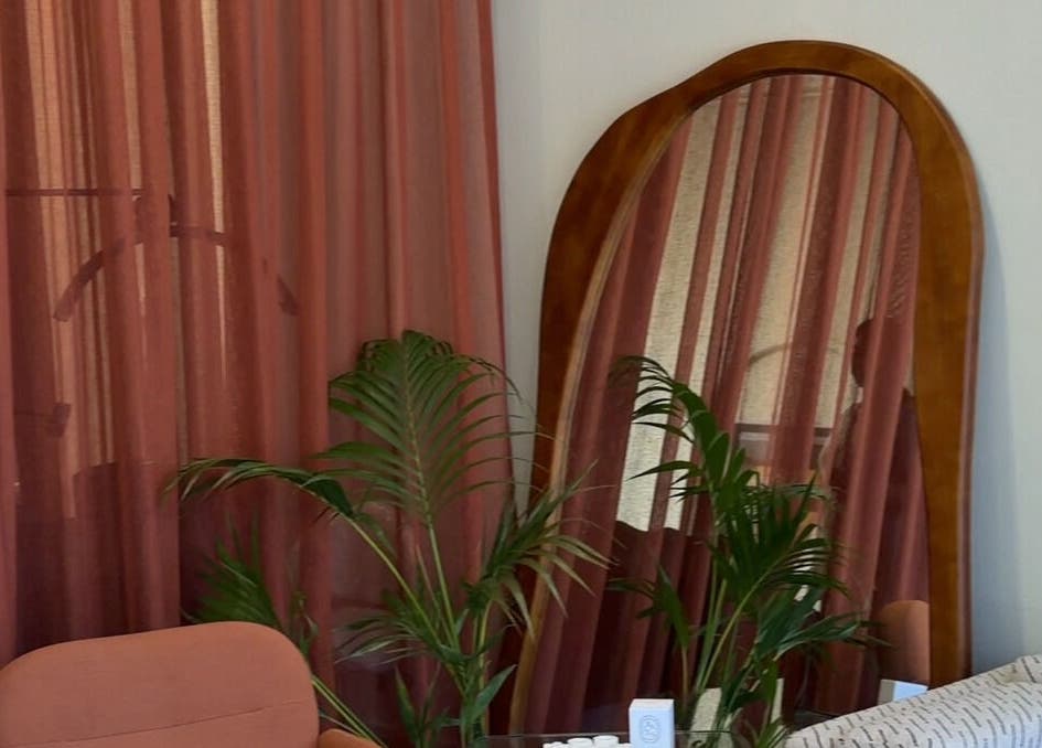 Elegant salon corner with lush plants and mirror at Through Her Eyes, Richmond, Victoria, AU.