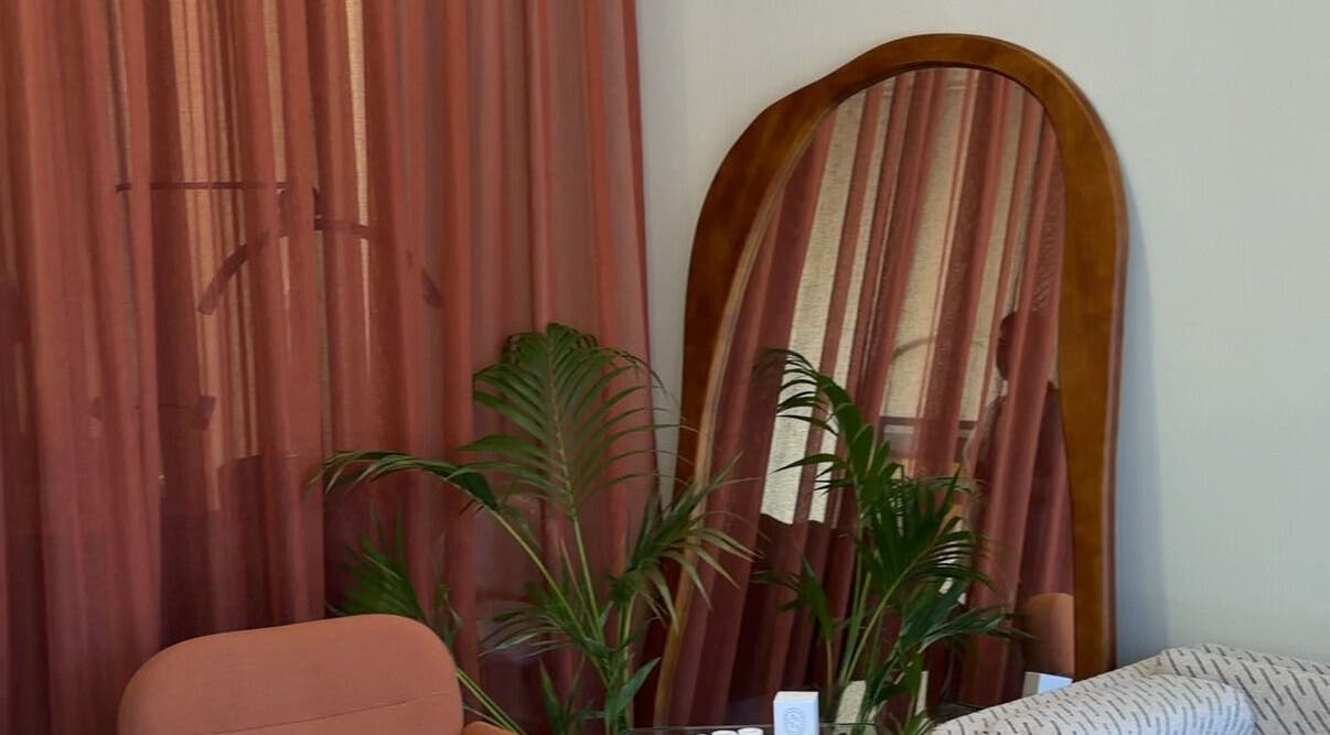 Elegant salon corner with lush plants and mirror at Through Her Eyes, Richmond, Victoria, AU.
