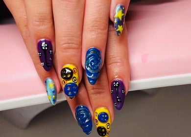 Vibrant cosmic nail art at Clawed & Cute, Michigan, Michigan, US showcasing starry designs and bold colors.