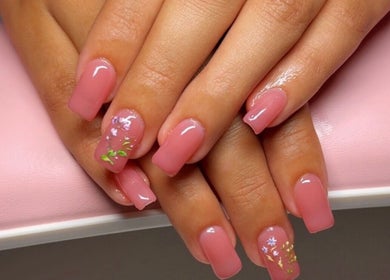Beautiful pink manicure with floral designs at Clawed & Cute, Michigan, Michigan, US.