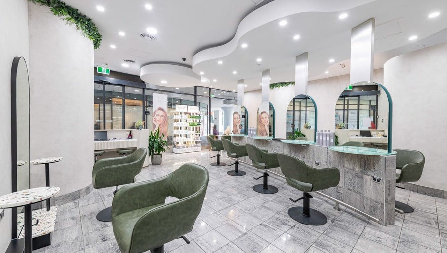 Interior of Monhairsalon in St Leonards, AU, featuring stylish seating and modern design.