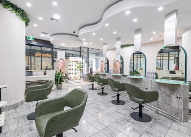 Interior of Monhairsalon in St Leonards, AU, featuring stylish seating and modern design.