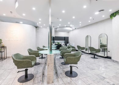 Modern interior of Monhairsalon in St Leonards, AU with stylish seating and mirrors.