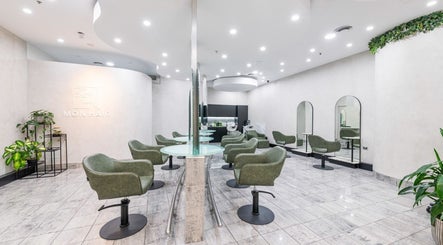 Modern interior of Monhairsalon in St Leonards, AU with stylish seating and mirrors.