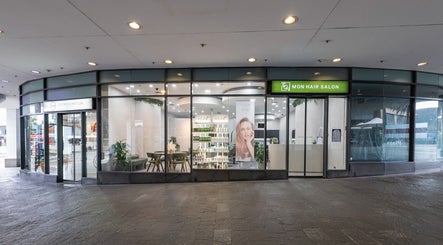 Exterior view of Monhairsalon at St Leonards, AU, showcasing a modern glass-fronted salon.