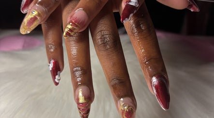 Elegant nail art in red and gold at Solembeauty in Labrador, Queensland, AU.