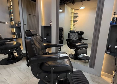 Comfortable black leather barber chairs at Trend Style Gents Salon, Dubai, Dubai, AE offering premium service.