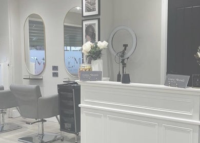 Elegant interior of Elle Rochford hair in Whiston, England, GB with modern chairs and decor.