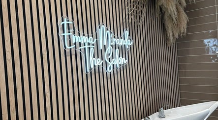 Elle Rochford hair's sleek interior with neon sign in Whiston, England, GB.