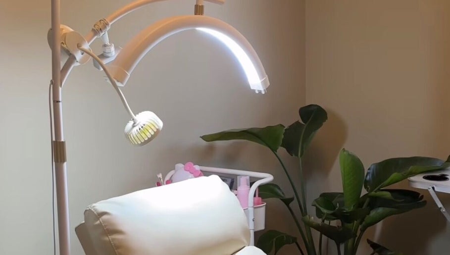 Cozy treatment room with modern lighting at Dk co., Sandton, Gauteng, ZA, featuring a lush plant decor.