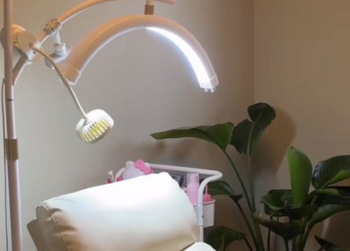 Cozy treatment room with modern lighting at Dk co., Sandton, Gauteng, ZA, featuring a lush plant decor.