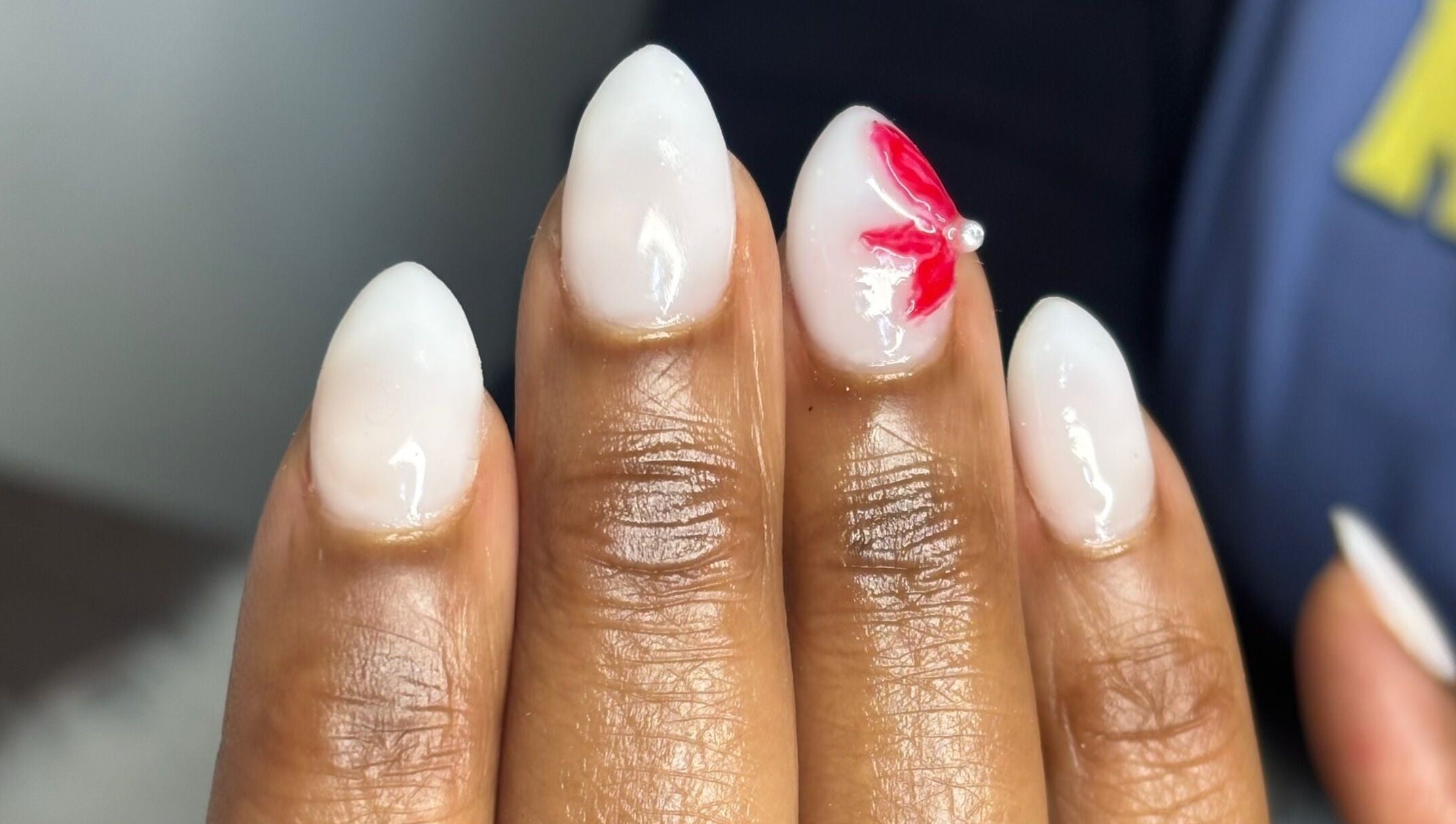 Stylish white nails with red flower design at Nail Diaries Studio, Sandton, Gauteng, ZA.