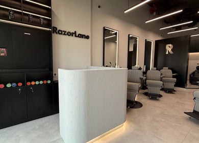 Interior of Razorlane Gents Salon L.L.C, Dubai, Dubai, AE, featuring modern chairs and a stylish reception.