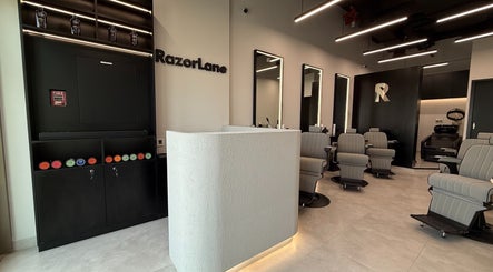 Interior of Razorlane Gents Salon L.L.C, Dubai, Dubai, AE, featuring modern chairs and a stylish reception.