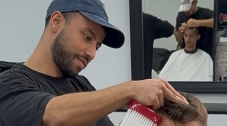 Barber styling hair at Abde_barber, Dublin, County Dublin, IE. Professional grooming in progress.