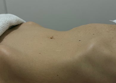 Relaxed body at Hellen Passinato Massage Therapist in London, GB, covered partially with a towel.
