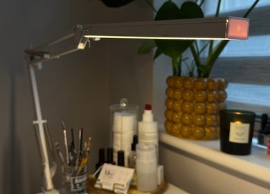 A well-lit beauty station at Mills Beauty, Oxenholme, England, GB with tools, products, and a vibrant plant.