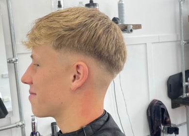 Man enjoying a precision fade haircut at FredtheBarber, Hull, England, GB, showcasing modern styling techniques.