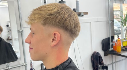 Man enjoying a precision fade haircut at FredtheBarber, Hull, England, GB, showcasing modern styling techniques.