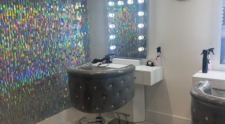 Chic styling station at Paula & Zoe Hairdressing, Banchory, Scotland, GB with illuminated mirrors and holographic decor.