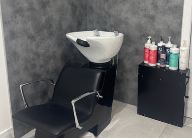 Modern wash station at Paula & Zoe Hairdressing in Banchory, Scotland, GB, with premium hair products displayed.