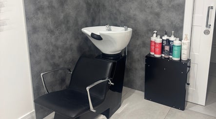 Modern wash station at Paula & Zoe Hairdressing in Banchory, Scotland, GB, with premium hair products displayed.