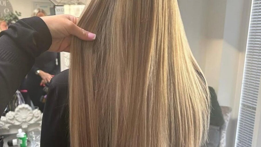 Smooth, blond hair styled at Hairbydlg in Dartford, GB, showcasing expert hairstyling in a bright salon.